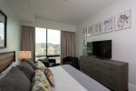 Master bedroom with 55in smart TV, full size dresser, and stunning views of the city
